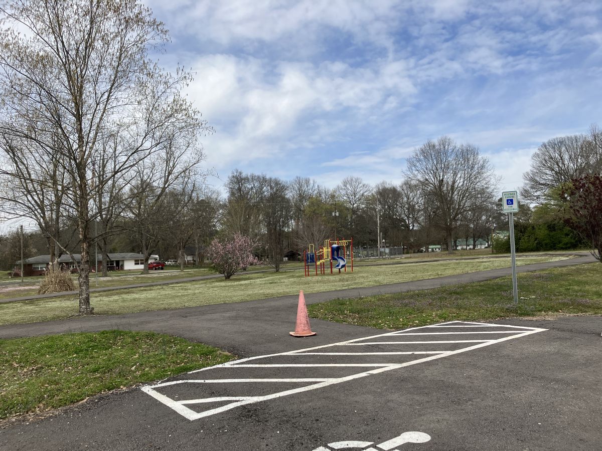 walking trail beside van accessible parking space. Sign denotes "Reserved parking - van accessible."